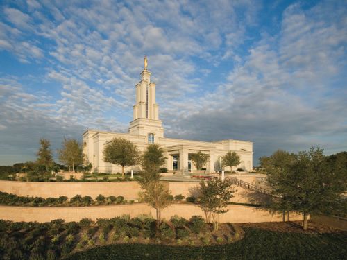 The entire San Antonio Texas Temple, with a view of the stairs leading to the entrance, the grounds, and trees and bushes lining the grounds.