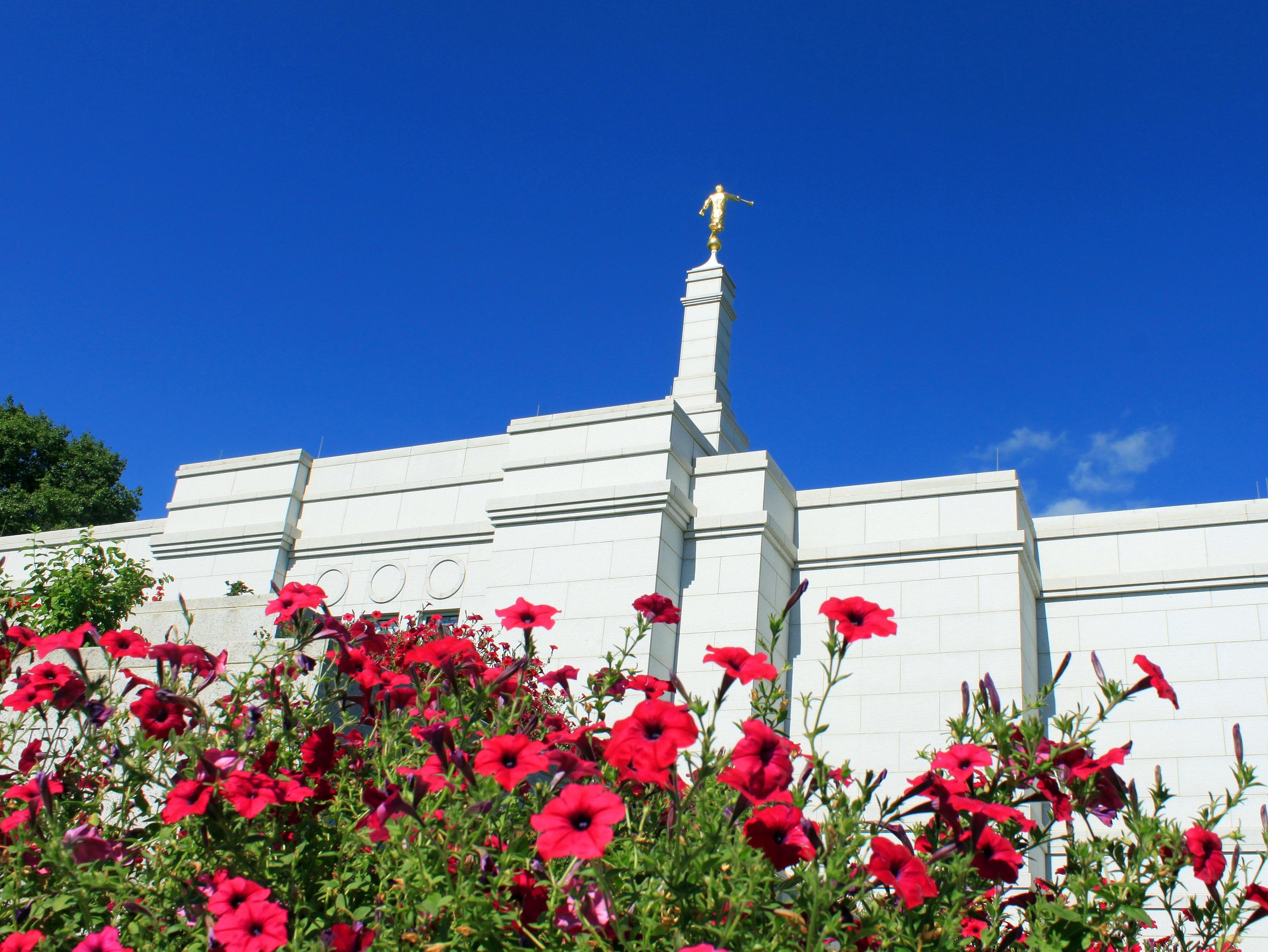 The west side of the Winter Quarters Nebraska Temple in the spring, with flowers.