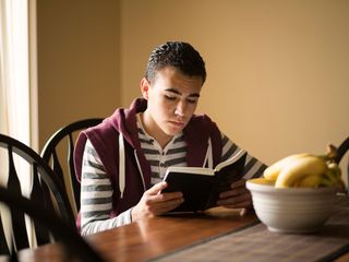 young man reading the Book of Mormon