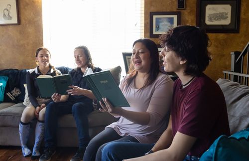 family singing a hymn together