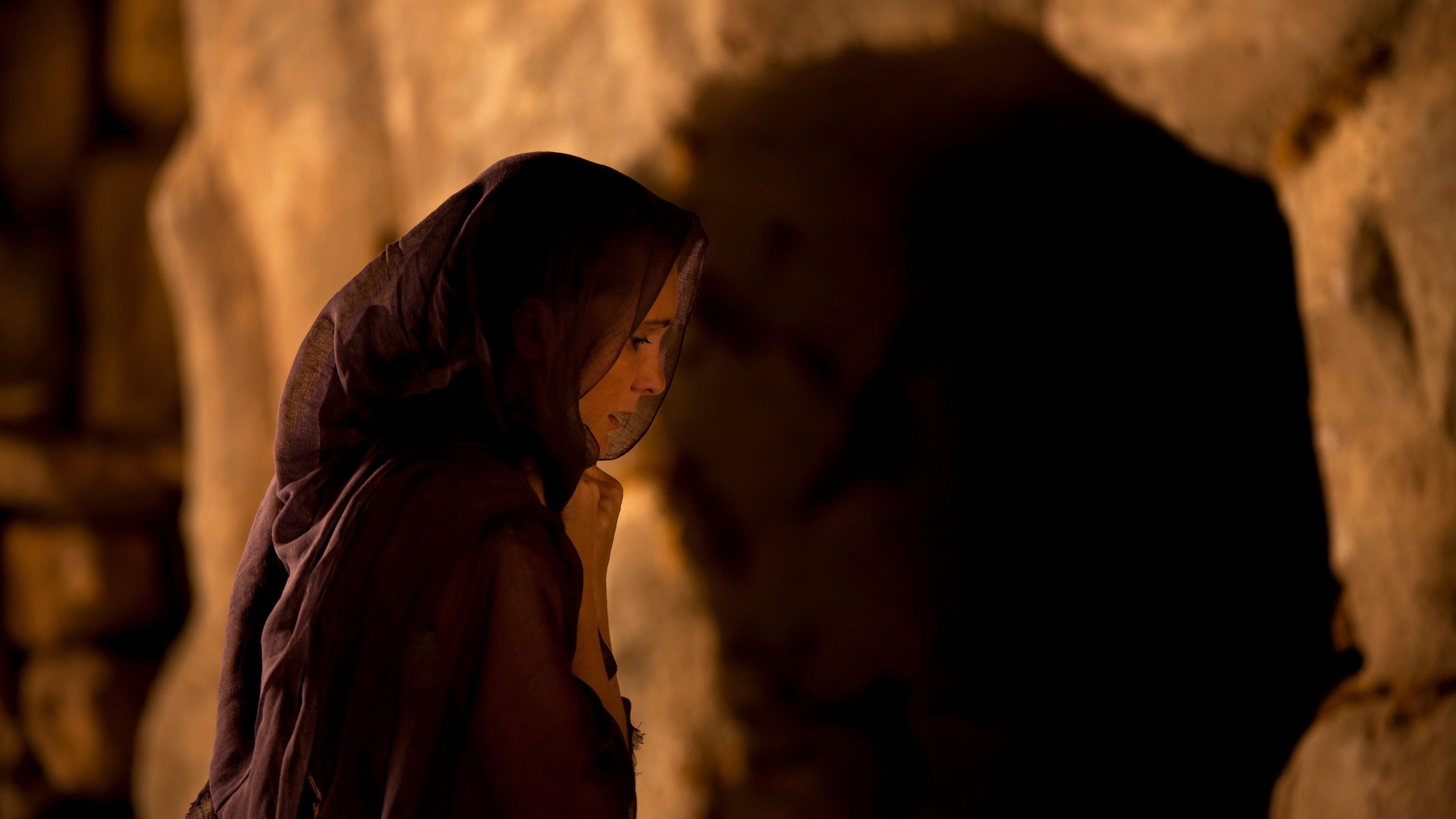 Mary Magdalene standing alone outside of an empty tomb.