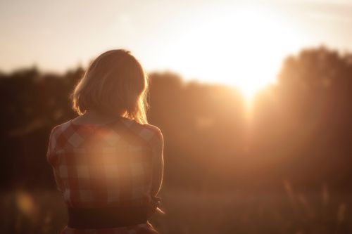 woman looking at sunset