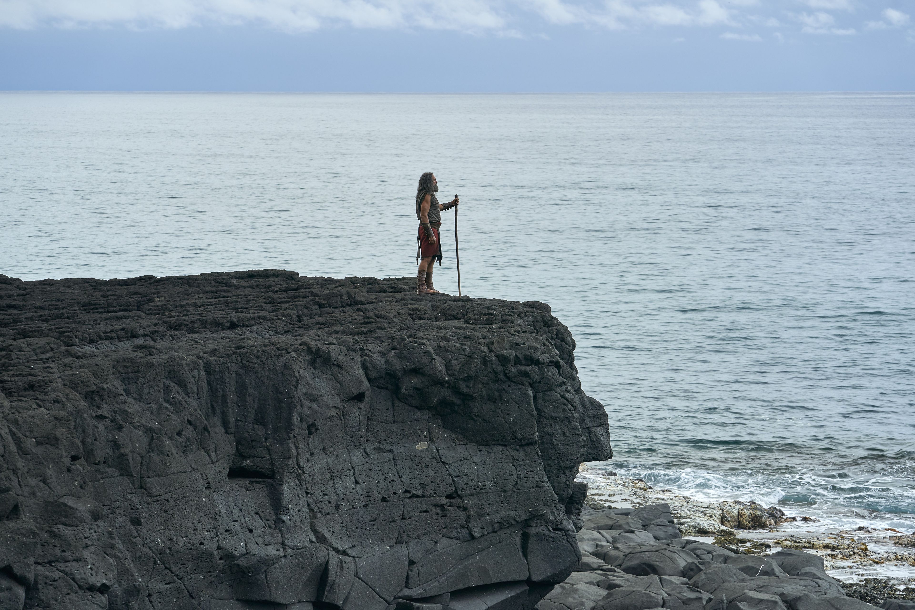 Moroni, son of Mormon, stands on a rocky shore overlooking the ocean.