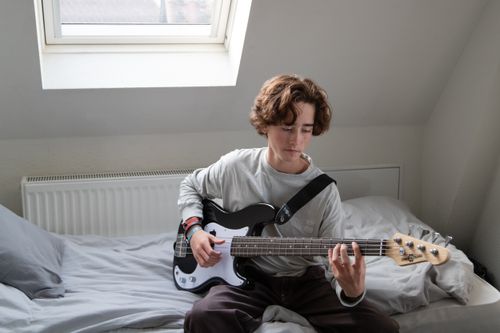 boy playing bass guitar