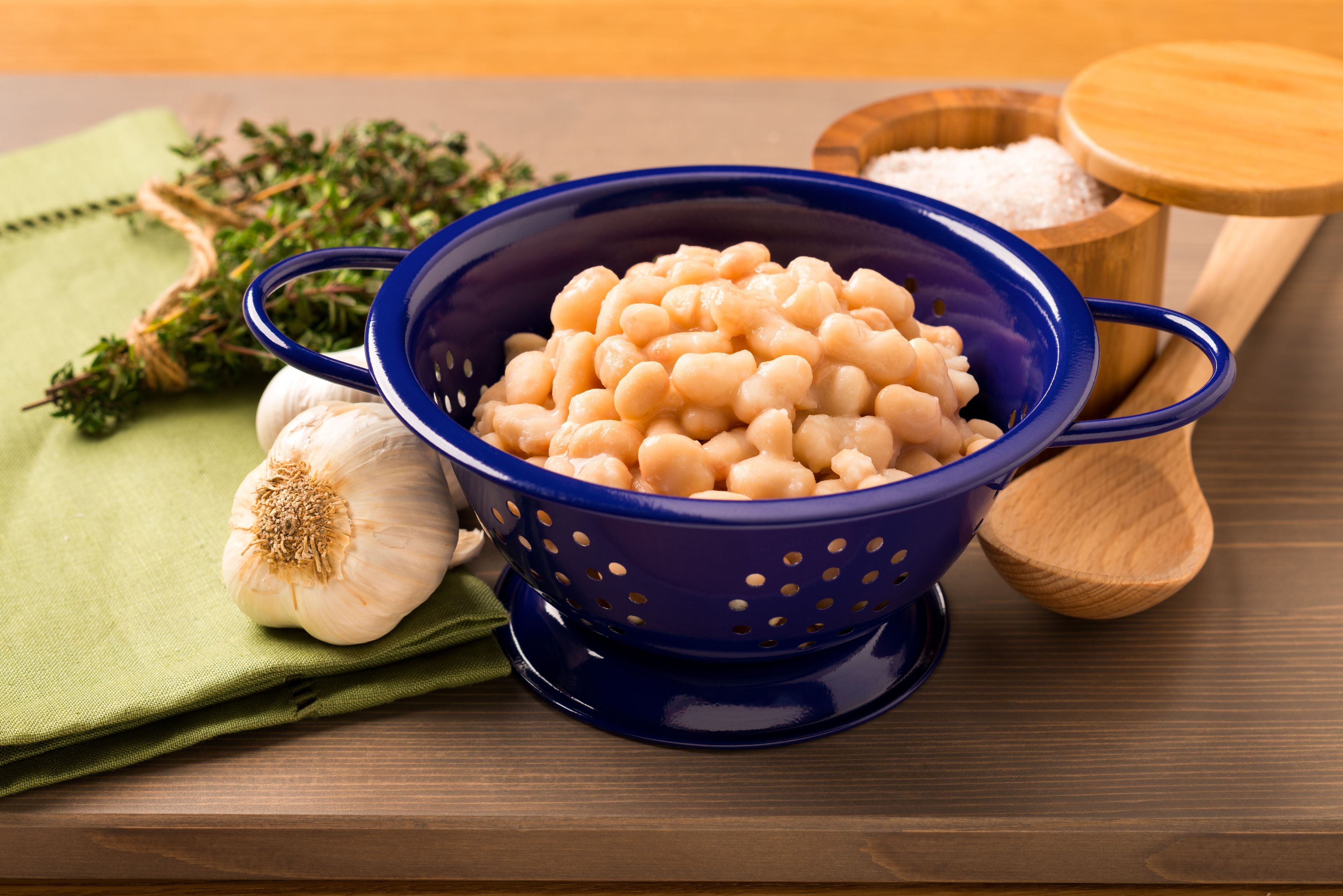 Beans in a colander with garlic.