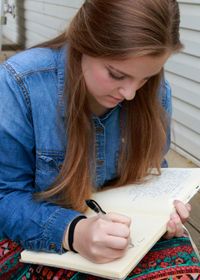 youth writing in journal