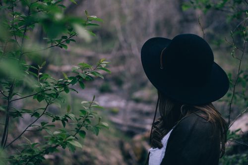 woman standing among trees