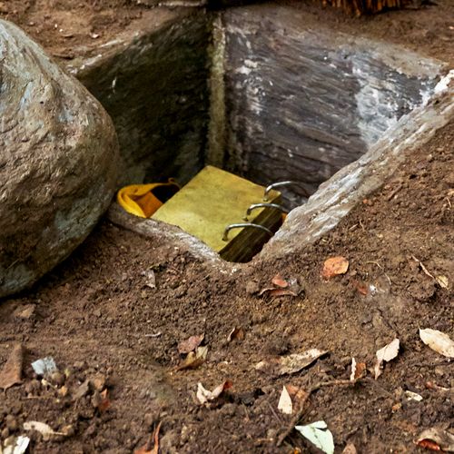 replica of stone box with gold plates inside