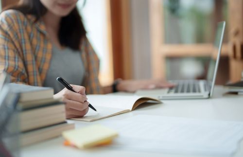 a woman writing in a notebook