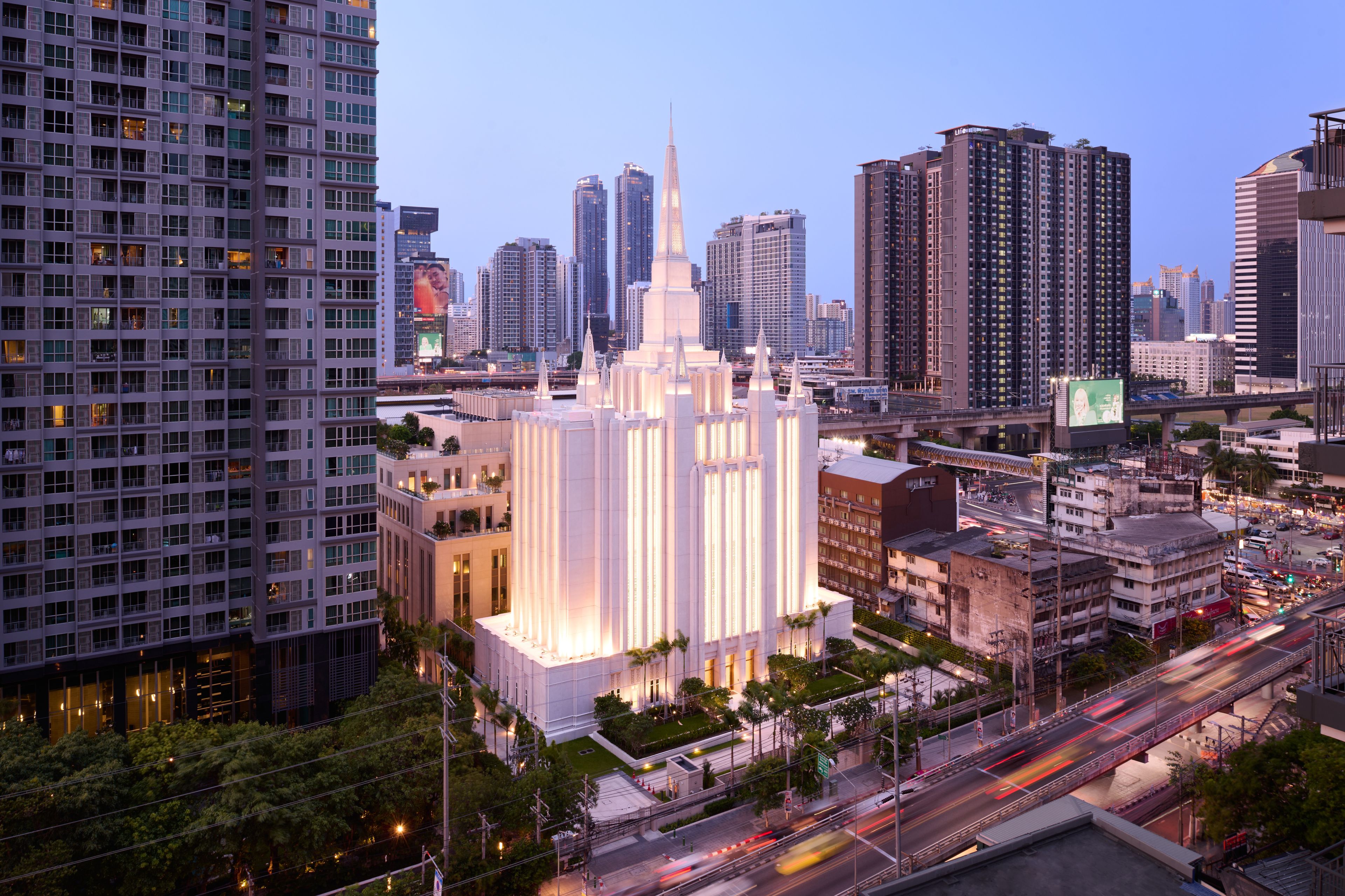 Images of the exterior of the Bangkok Thailand Temple. Images feature the architectural detail of the temple taken from a distance so you see the temple and the surrounding skyscrapers. 