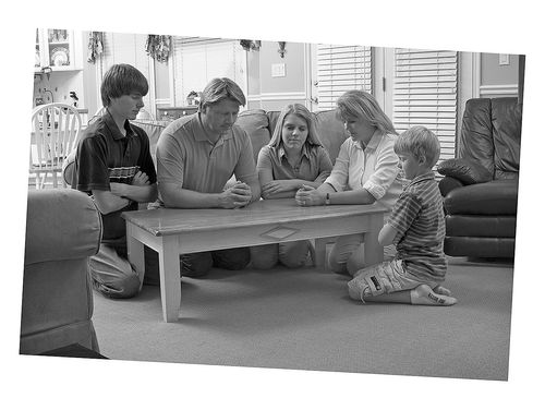 Family kneeling in prayer