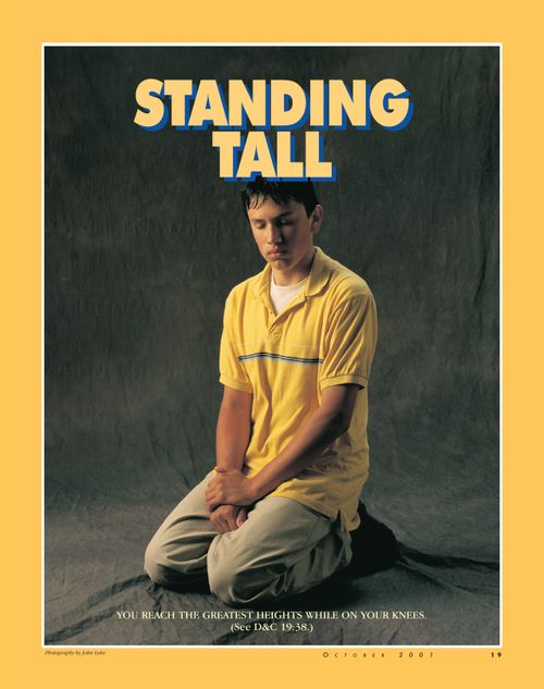 A poster of a young man praying, paired with the words “Standing Tall."