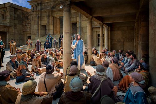 Christ standing in the middle of a large crowd, teaching them.