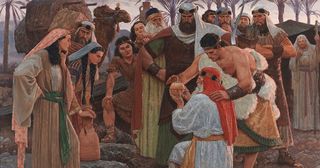 Lehi and his family looking at the Liahona