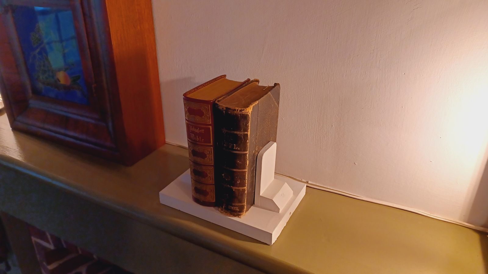 Two books on a shelf between bookstands