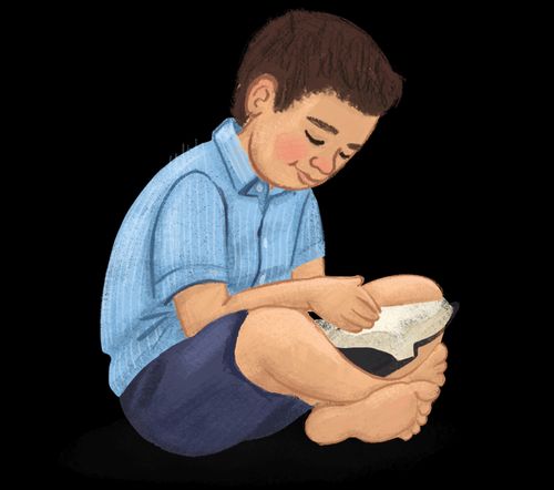 A boy sitting and reading a book