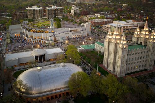 An aerial view at dusk of the temple, visitors’ center, Tabernacle, and Conference Center on Temple Square.