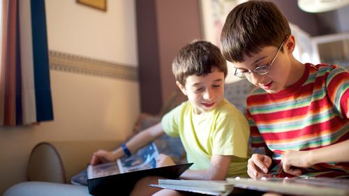 brothers looking at a photo album