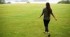 a woman walks across a field