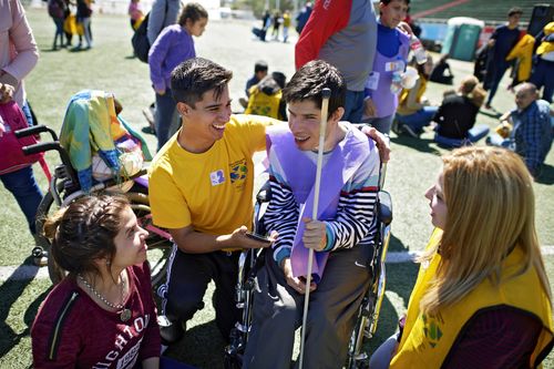 young people, one in wheelchair