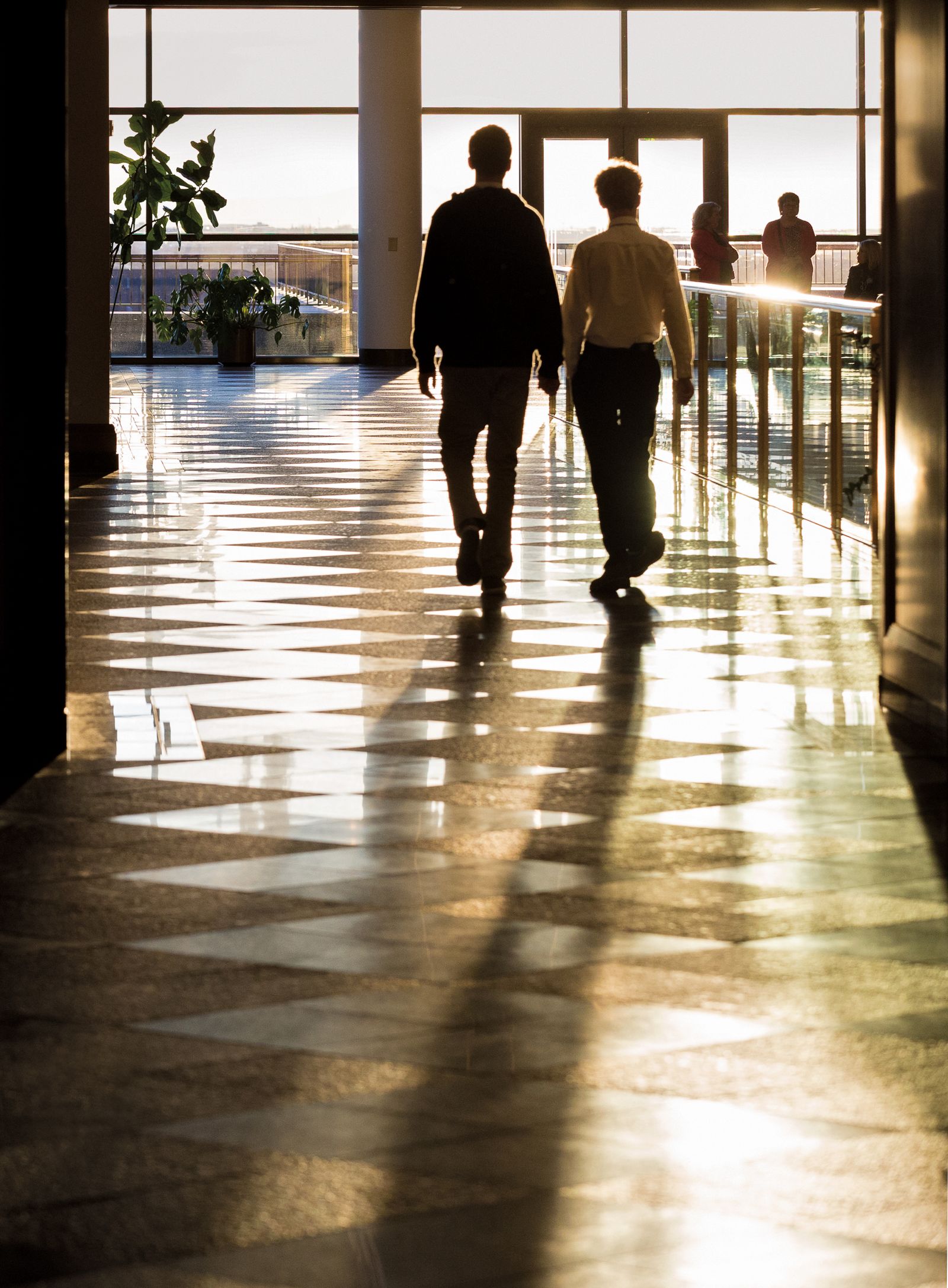 Two young men walking inside the Conference Center.