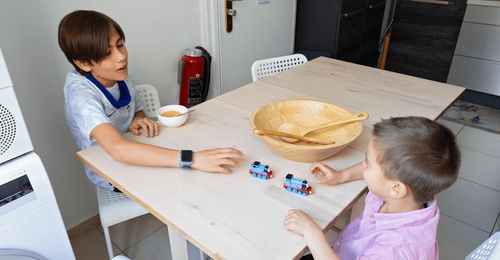 young man playing with younger brother