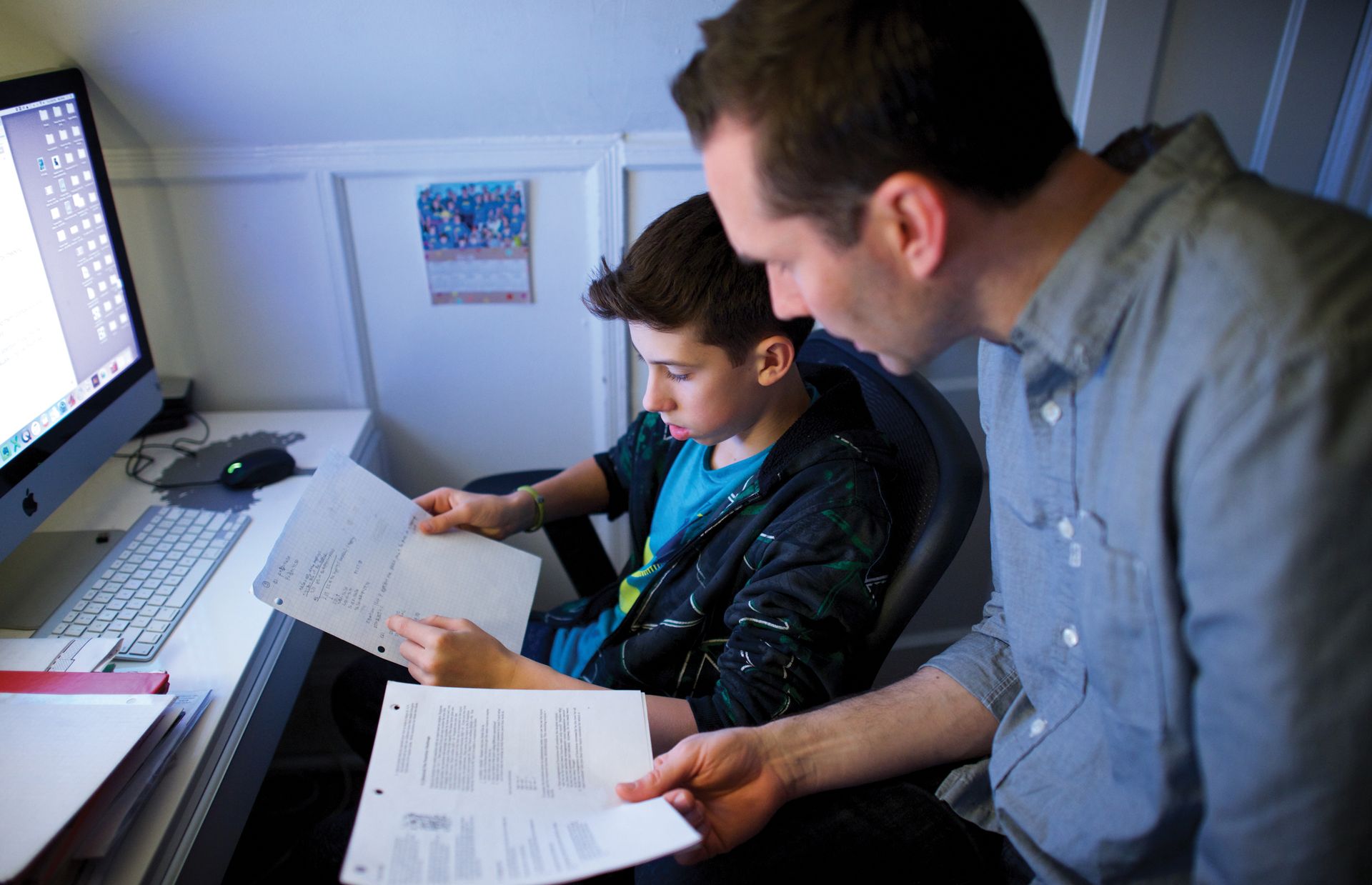 Bishop Mikael Rinne helps his son, Kai, with his homework. In the Rinne home, there’s room for both faith and science.