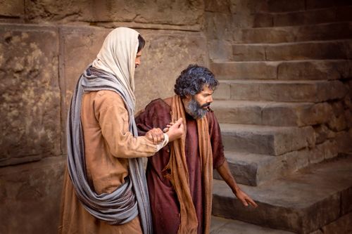 Christ standing near stone steps with a blind man, who is holding onto His arm.