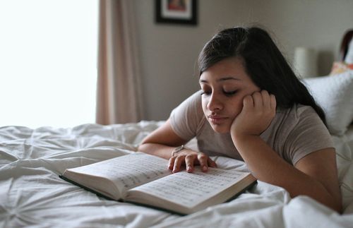 girl reading hymnbook