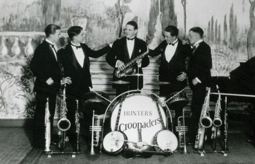 A black-and-white photograph of President Howard W. Hunter standing with the four members of his band, Hunter’s Croonaders, all wearing tuxedos.