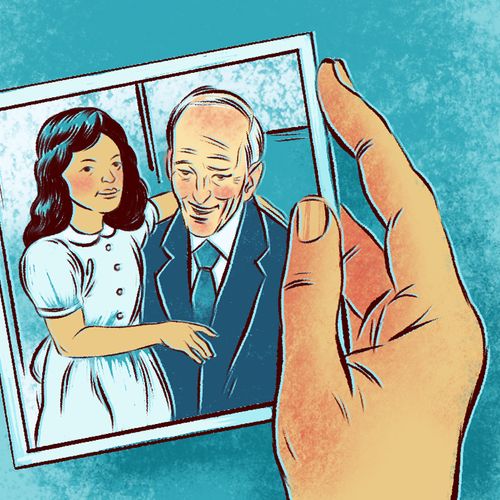 hand holding a picture of President Nelson with a girl