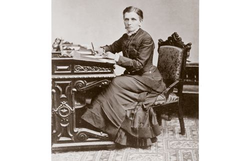 Emmeline B. Wells seated at desk