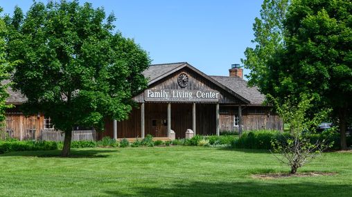 A large wooden building with a sign that reads “Family Living Center” on the front.