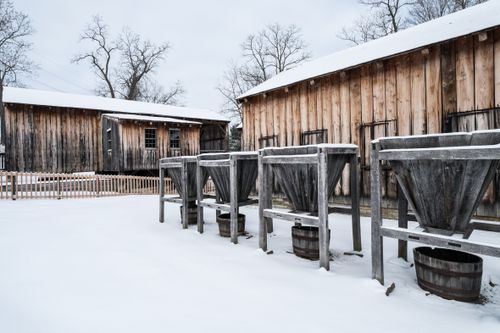 The exterior of the sawmill and the ashery in Kirtland, Ohio, both of which are covered in snow during the wintertime.