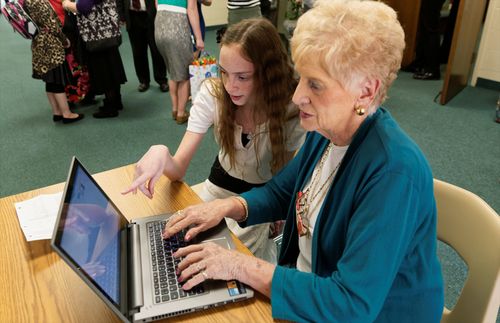 Young woman helping with computer