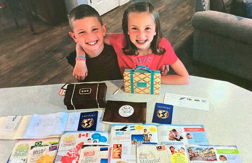 brother and sister showing copies of the Friend