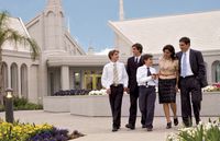 A family dressed in Sunday clothes walking on the grounds of the Buenos Aires Argentina Temple.