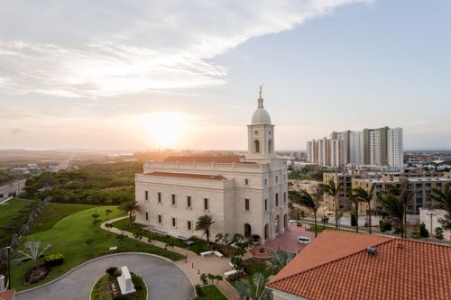 A sunset picture of the Barranquilla Colombia Temple and the surrounding area.