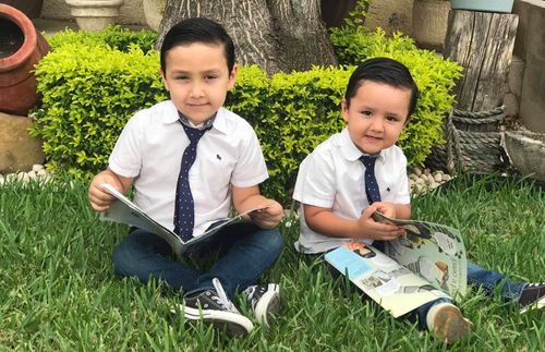 two brothers reading Friend outside