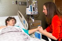 woman visiting older woman in hospital