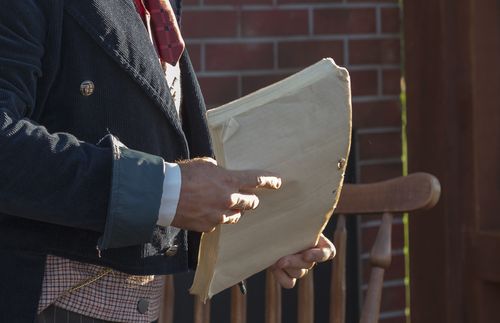 man carrying manuscript pages