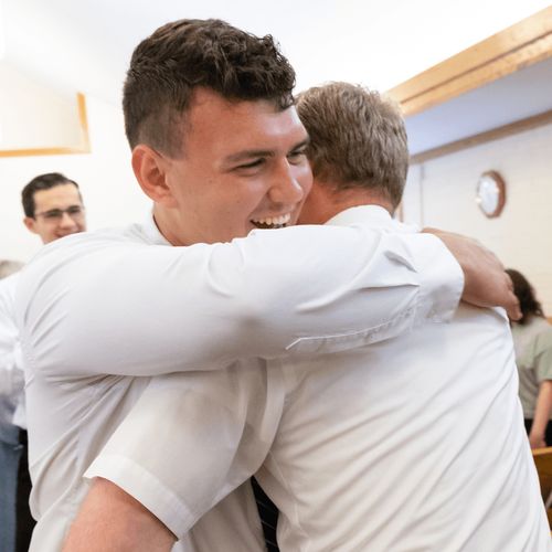 young man and man embracing