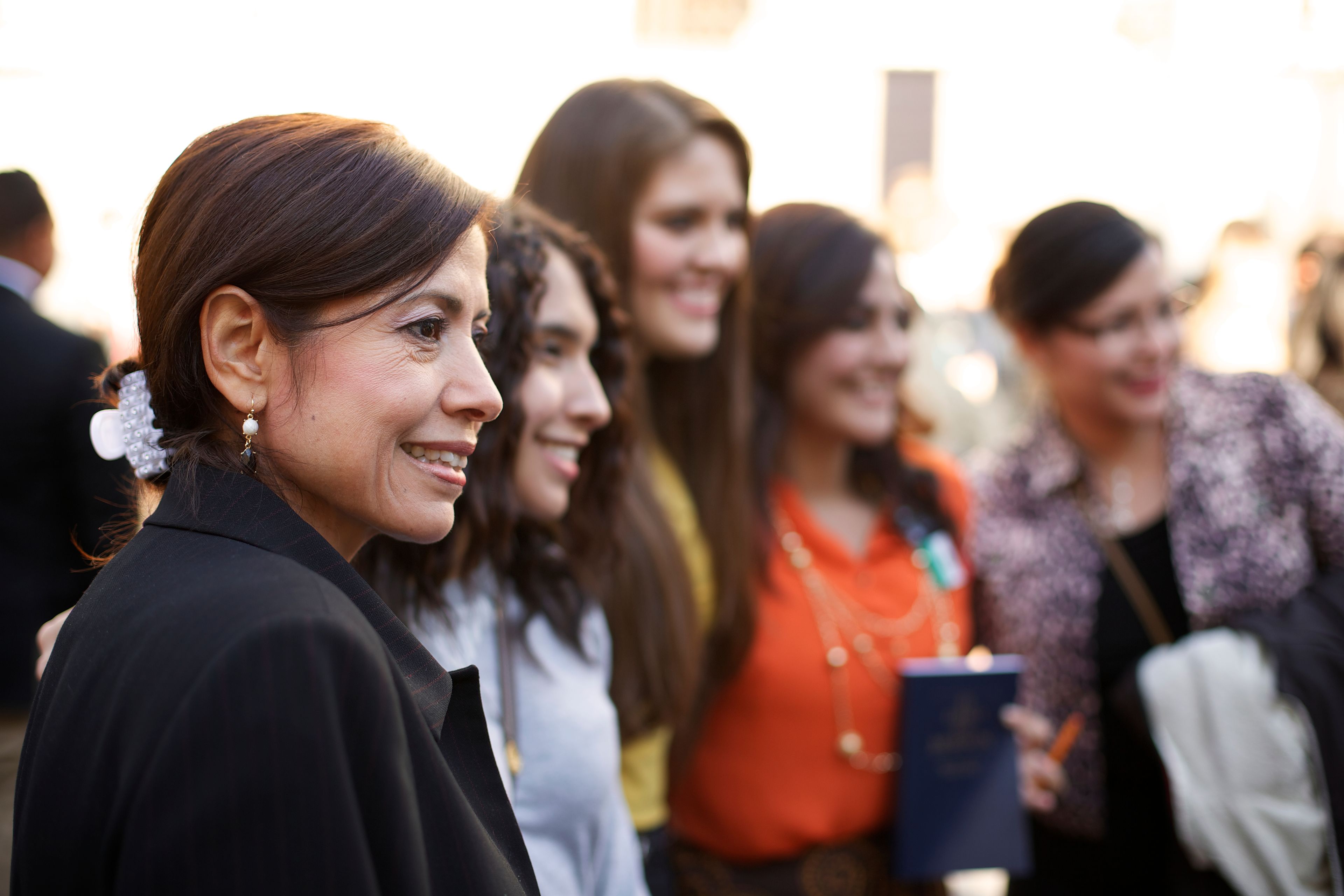 A woman standing in a group with other women outside the Conference Center.  
