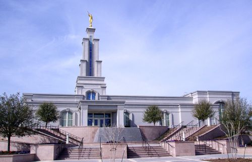 Stairs leading up to the front entrance of the San Antonio Texas Temple, with a view of the doors and spire.