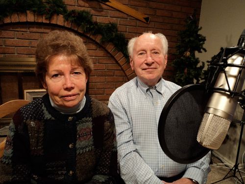 A man and a woman (Werner Schmidt and Morgot Sadowski) beside a radio microphone.