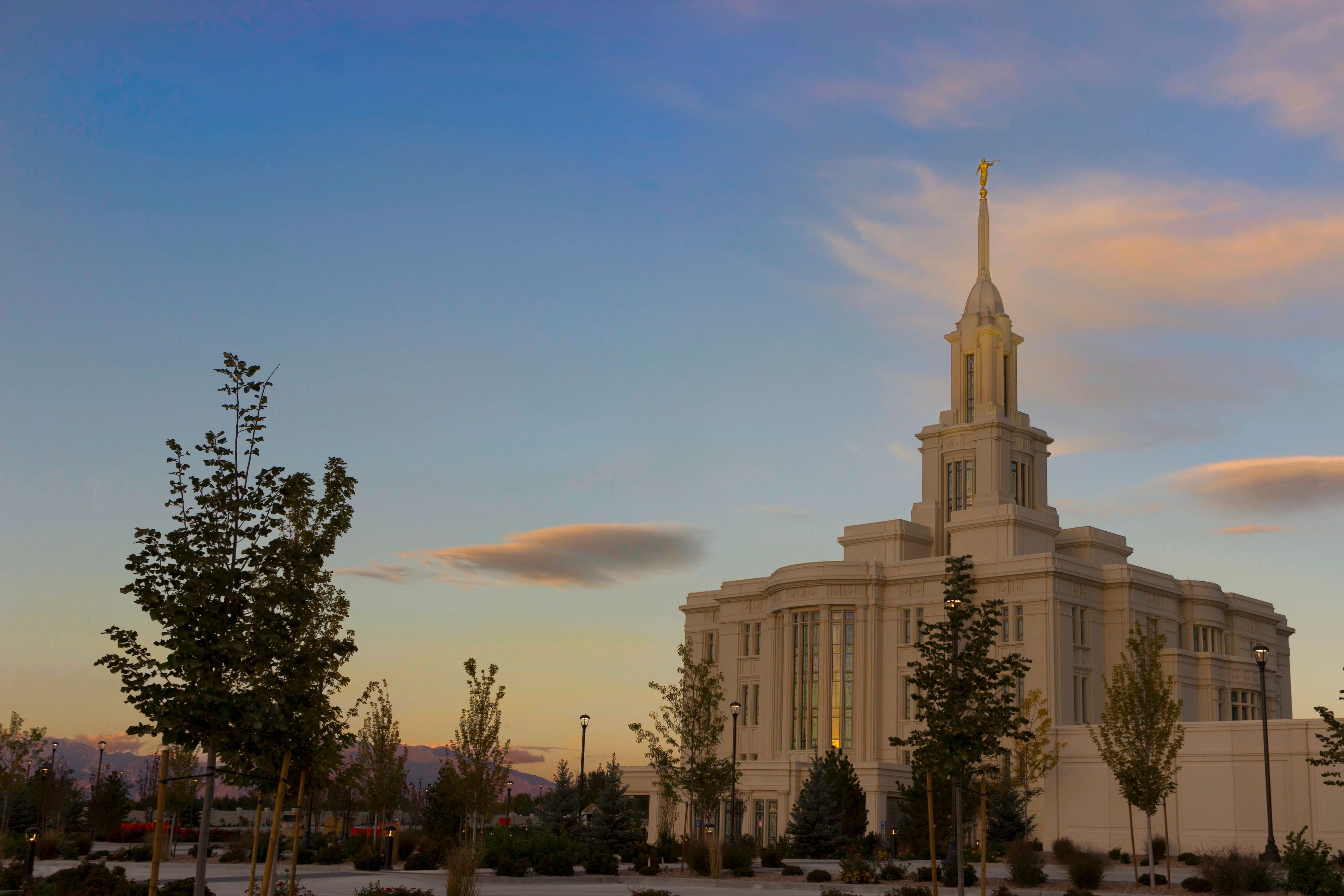 A side view of the Payson Utah Temple during the evening, including scenery.  