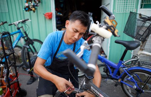 man repairing a bicycle