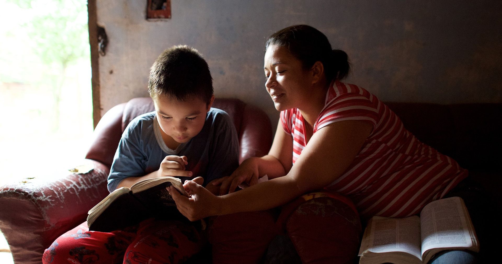 Mother and son reading scriptures together.