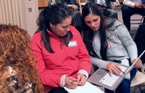 two women looking at a laptop computer