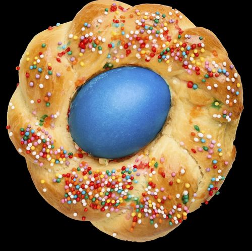 round loaf of bread with colored egg in the middle